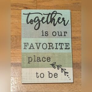 Wooden wall decor with saying "Together is our favorite place to be"